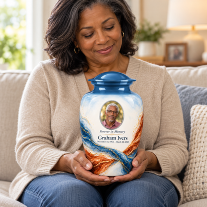 Yatskia Steelblue Torsion personalized urn held on a seated adult’s lap