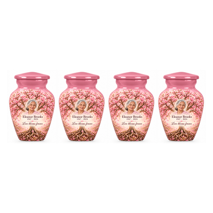 Four matching Pink Cherry Blossom Tree of Life keepsake urns with sample photo and text on a white background