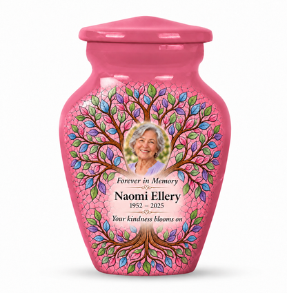 One pink Tree of Life keepsake urn with mosaic-style leaves, Naomi Ellery sample portrait and memorial text on white.
