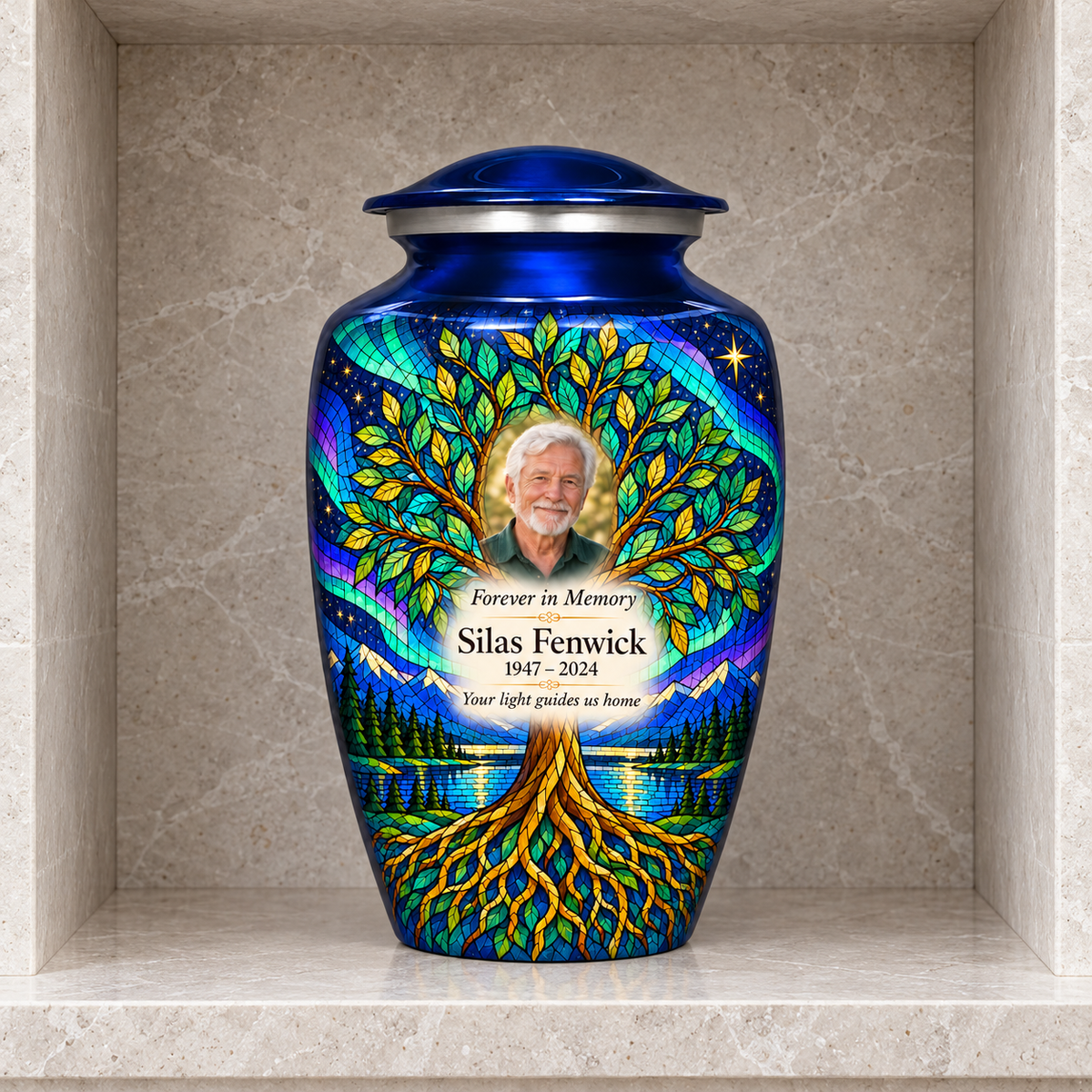 Blue Tree of Life adult urn with Silas Fenwick sample portrait and memorial text inside a pale stone columbarium niche.