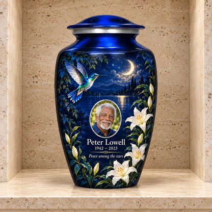 Blue hummingbird adult urn with white lilies and sample portrait displayed in a stone columbarium niche