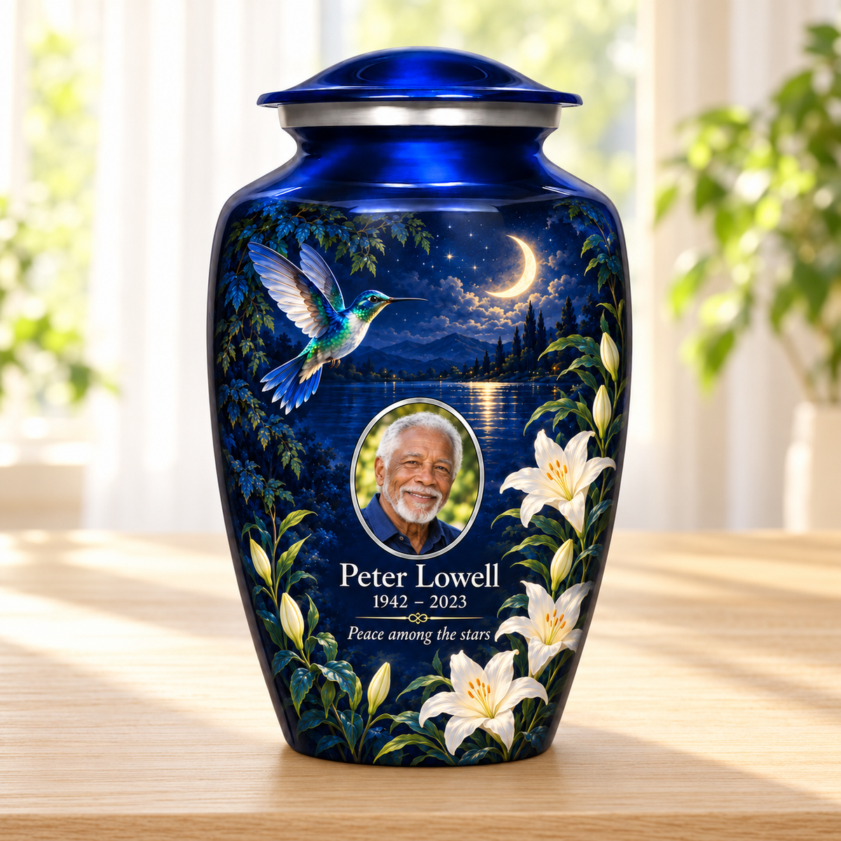 Blue hummingbird adult urn with white lilies and sample photo and text displayed in a sunlit home
