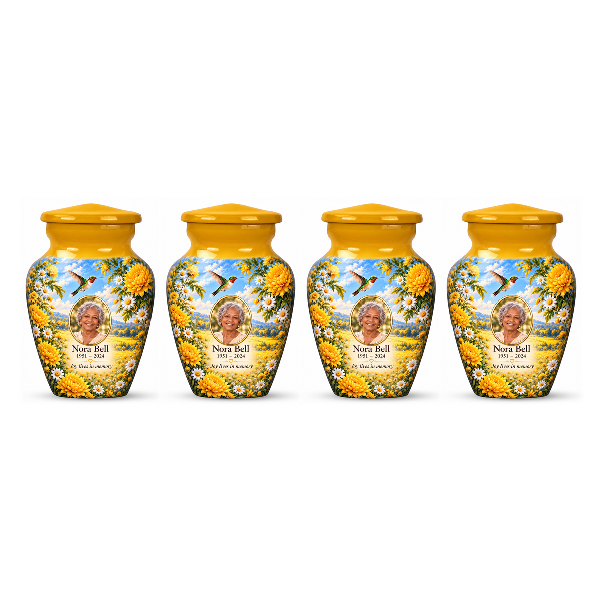 Four matching yellow hummingbird keepsake urns with chrysanthemums, white daisies and Nora Bell sample photo and text