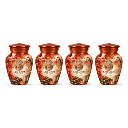 Four matching orange hummingbird keepsake urns with Leila Grant sample photo and text