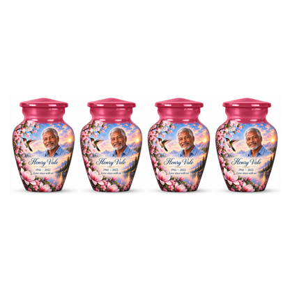 Four matching pink hummingbird keepsake urns with Henry Vale sample photo and text