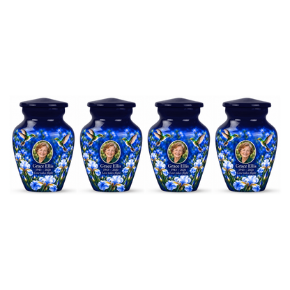 Four matching blue hummingbird keepsake urns with Grace Ellis sample photo and text
