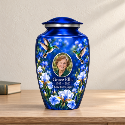 Blue hummingbird adult urn with Grace Ellis sample photo and text displayed on a memorial console