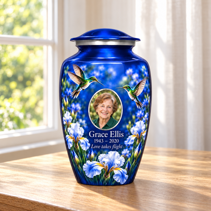 Blue hummingbird adult urn with two hummingbirds and pale blue irises and Grace Ellis sample photo and text in a sunlit home