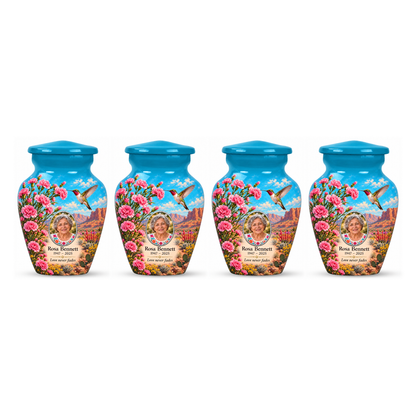 Four matching blue hummingbird keepsake urns with Rosa Bennett sample photo and text