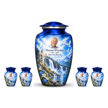 One blue adult cross urn and four keepsakes with blue waterfalls and white flowers arranged on white.