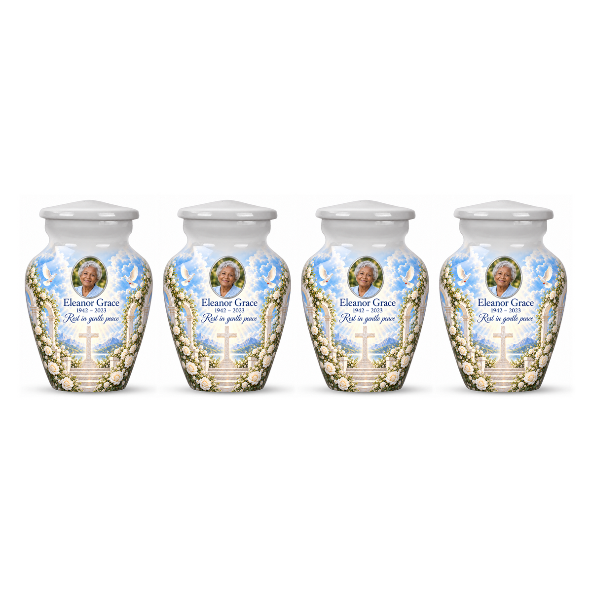 Four matching white cross keepsake urns with white roses and garden steps arranged on white.