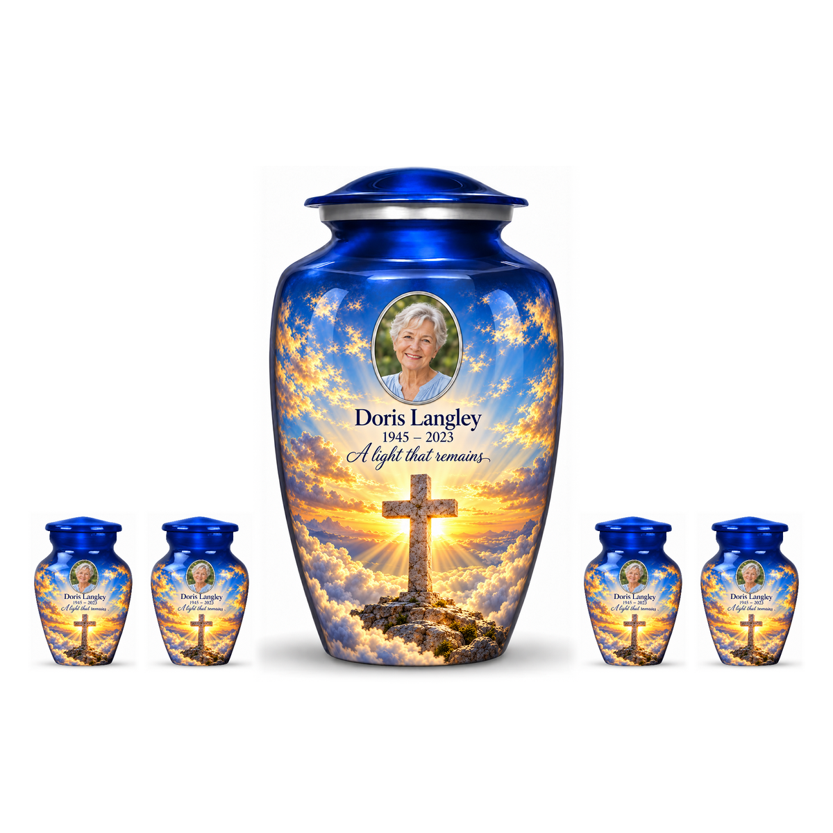 One blue adult cross urn and four keepsakes with golden sunlight and clouds arranged on white.