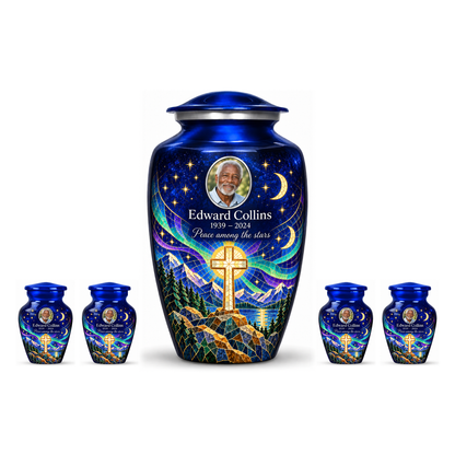 One blue adult cross urn and four keepsakes with a printed moonlit mosaic arranged on white.