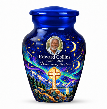 One blue cross keepsake urn with a printed moonlit mosaic, sample portrait and tribute on white.