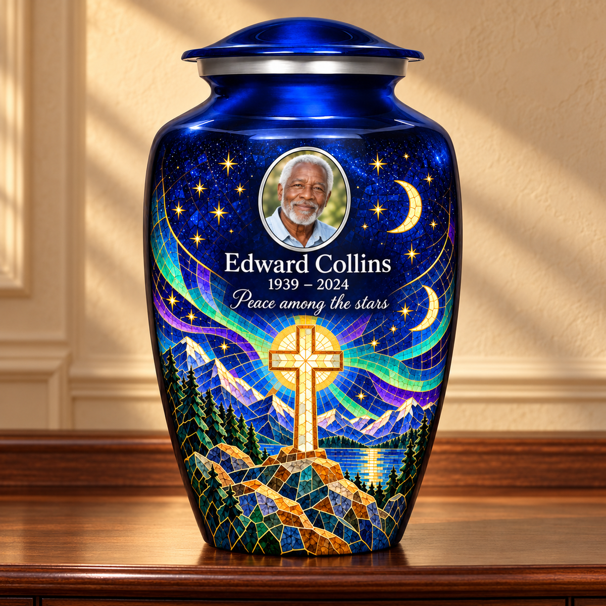 Blue adult cross urn with a printed moonlit mosaic displayed on a memorial console.