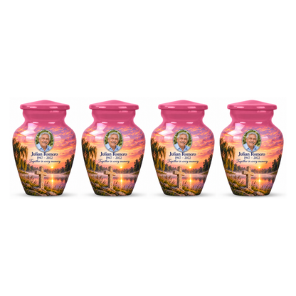 Four matching pink cross keepsake urns with a pink lakeside dawn arranged on white.