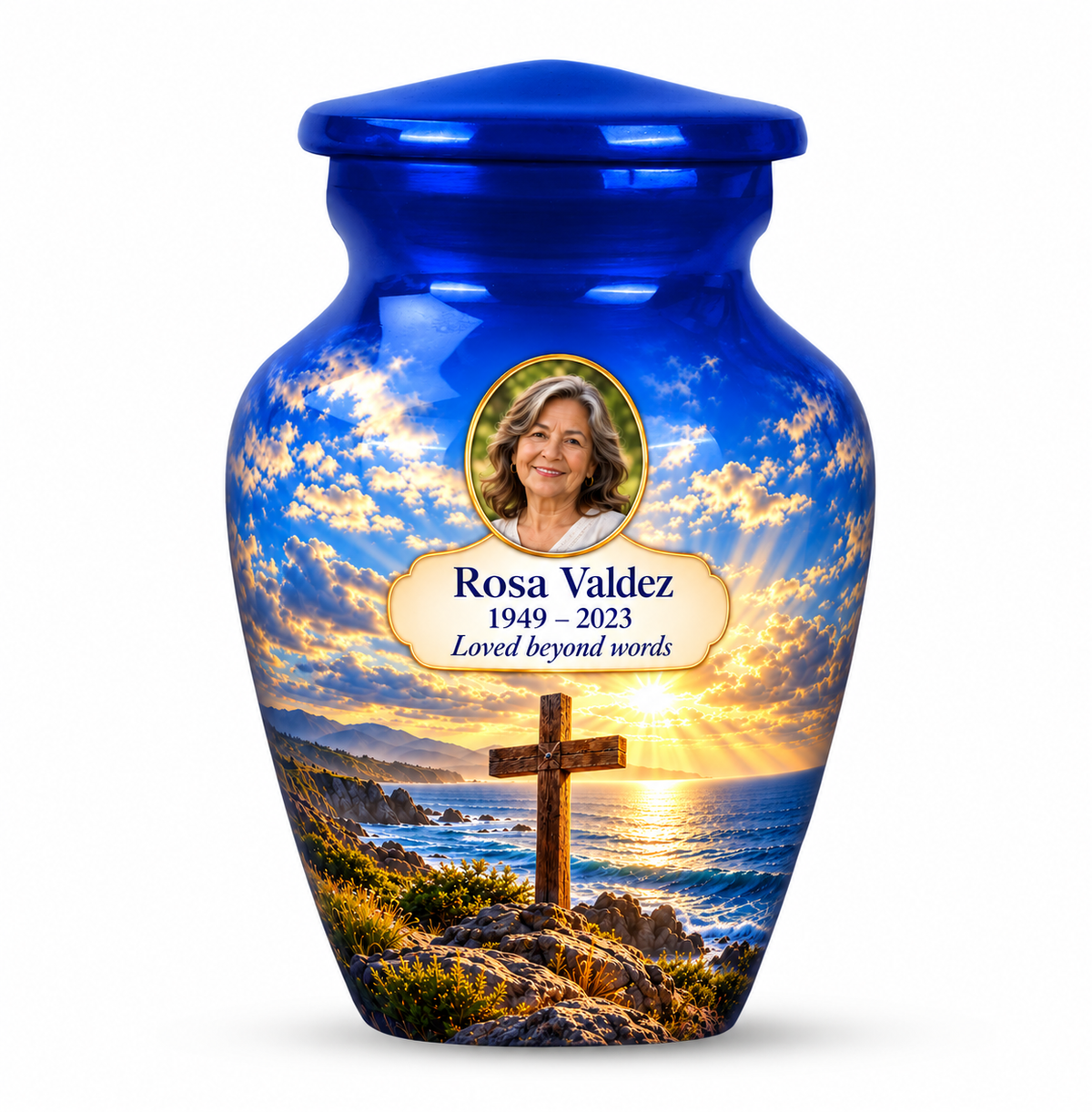 One blue cross keepsake urn with a blue coastal sunset, sample portrait and tribute on white.