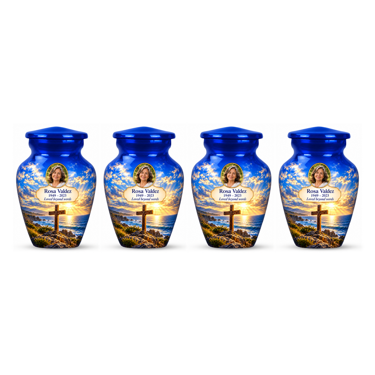 Four matching blue cross keepsake urns with a blue coastal sunset arranged on white.