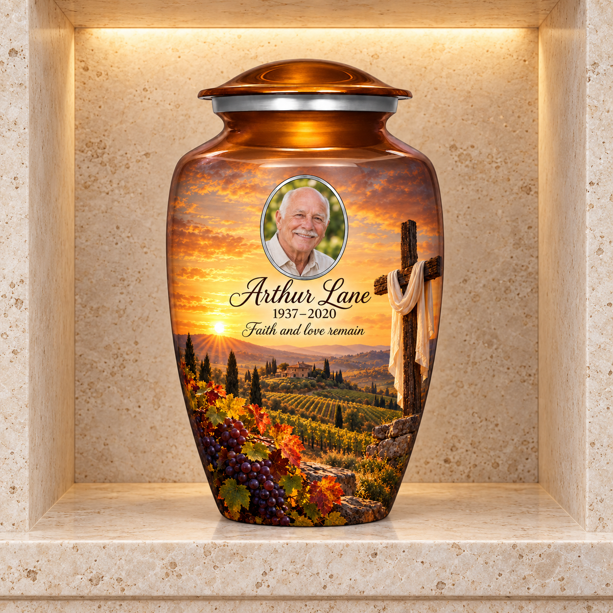 Orange adult cross urn with an amber vineyard scene displayed in a stone columbarium niche.