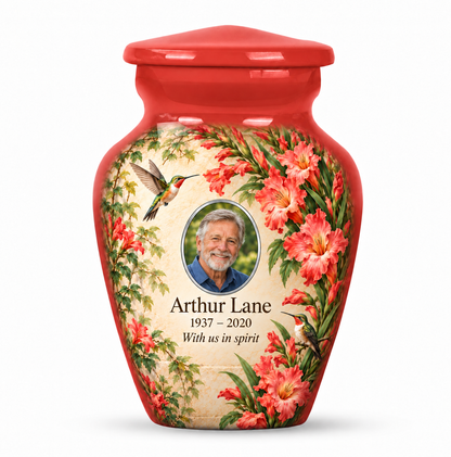 One red hummingbird keepsake urn with coral gladiolus flowers and leafy greenery and Arthur Lane sample photo and text