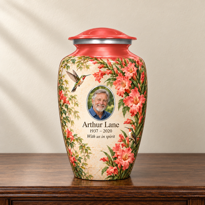 Red hummingbird adult urn with Arthur Lane sample photo and text displayed on a memorial console