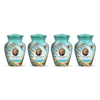 Four matching seafoam green hummingbird keepsake urns in a row on white, each with Joseph Quinn sample portrait and memorial text.