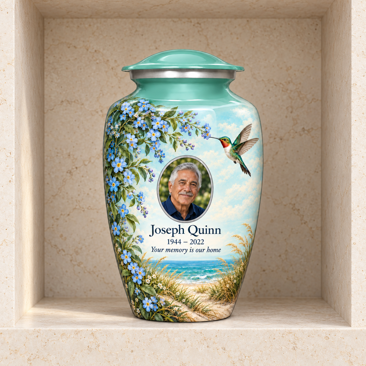 Seafoam green hummingbird adult urn with Joseph Quinn sample portrait and memorial text in a stone columbarium niche.