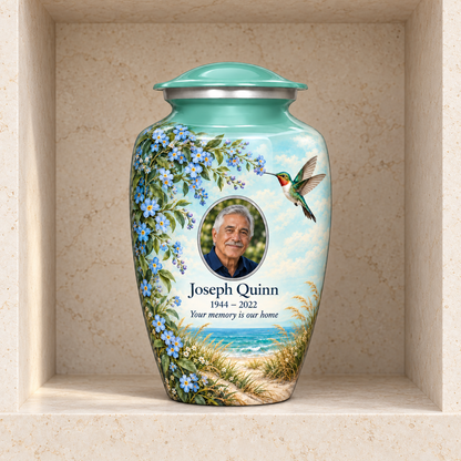 Seafoam green hummingbird adult urn with Joseph Quinn sample portrait and memorial text in a stone columbarium niche.