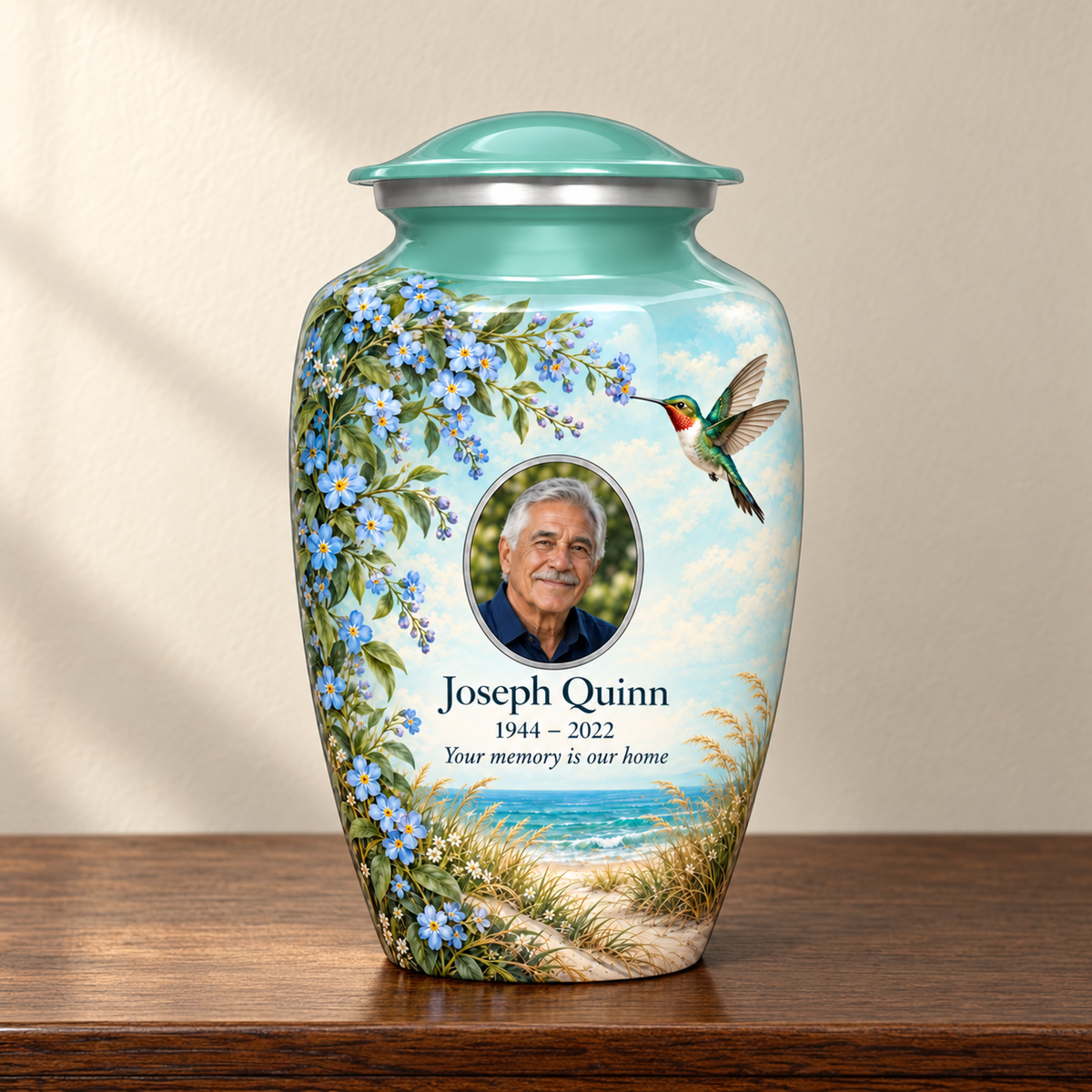 Seafoam green hummingbird adult urn with Joseph Quinn sample portrait and memorial text on a wooden memorial console.