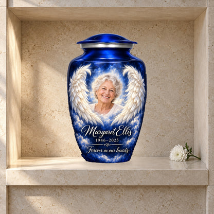 Blue angel wings adult urn displayed in a stone columbarium niche.