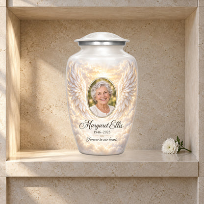 white adult urn with Pearl Dawn Wings angel wings artwork displayed in a columbarium niche.