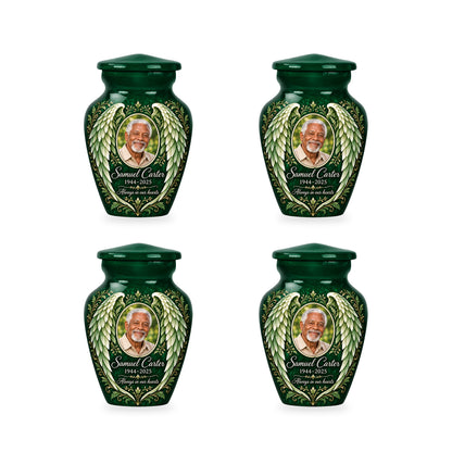 Four matching green angel wings keepsake urns with sample photo and inscription.
