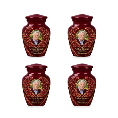Four matching red angel wings keepsake urns with sample photo and inscription.