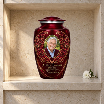 red adult urn with Golden Contour Wings angel wings artwork displayed in a columbarium niche.