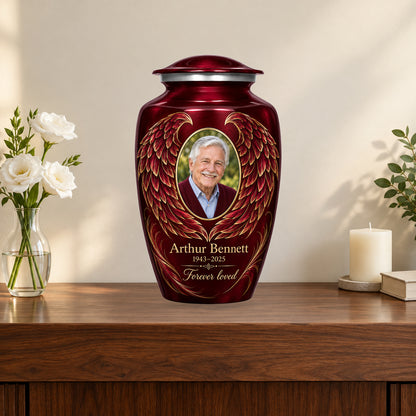 red personalized angel wings adult urn on a memorial console.