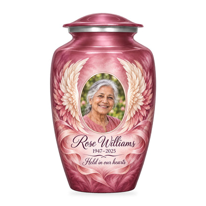 pink adult urn with Soft Ribbon Wings angel wings artwork, fictional sample portrait and personalized inscription on white.