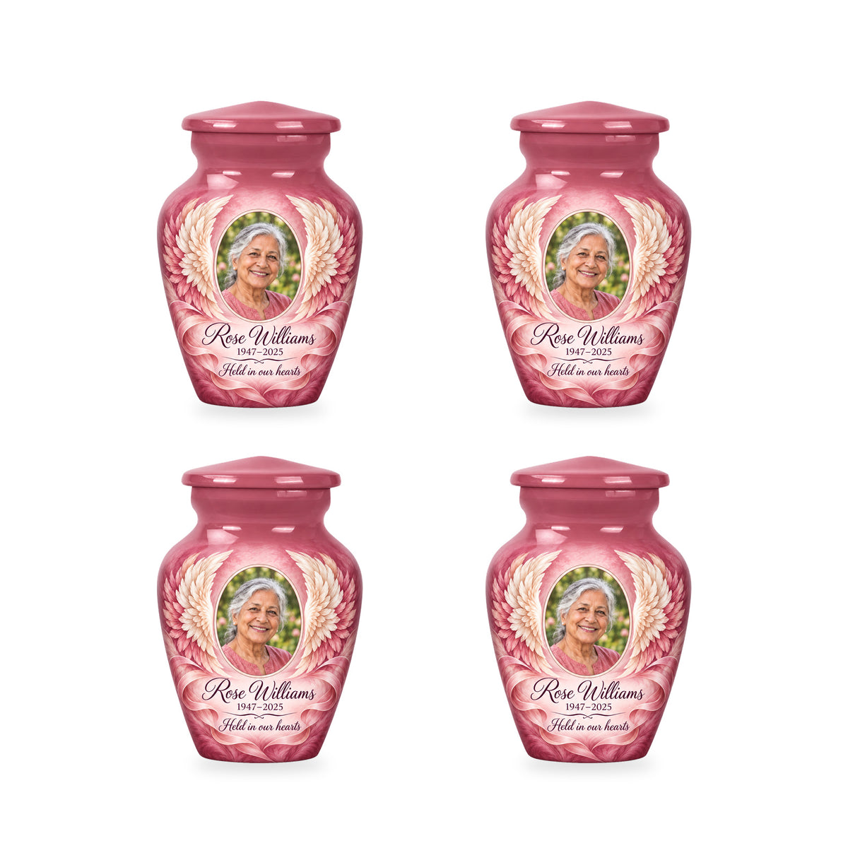 Four matching pink angel wings keepsake urns with sample photo and inscription.