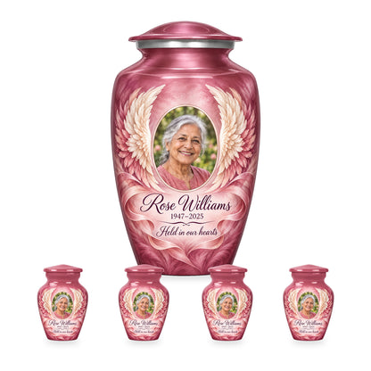 pink adult angel wings urn with four matching keepsakes shown in proportional 10-inch and 3-inch sizes.