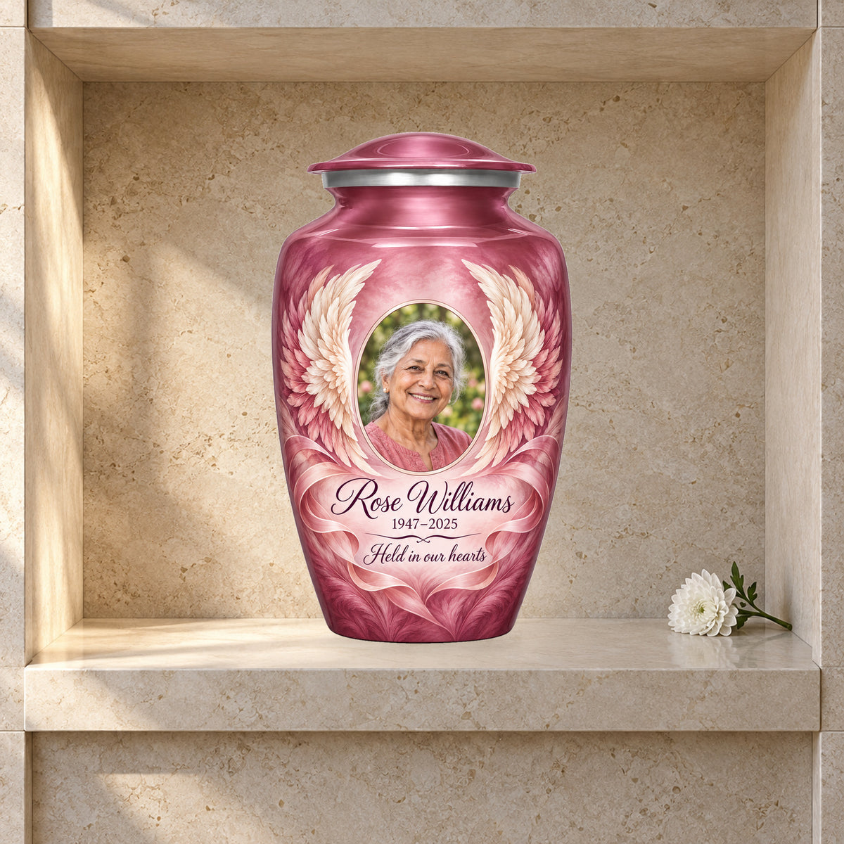 pink adult urn with Soft Ribbon Wings angel wings artwork displayed in a columbarium niche.