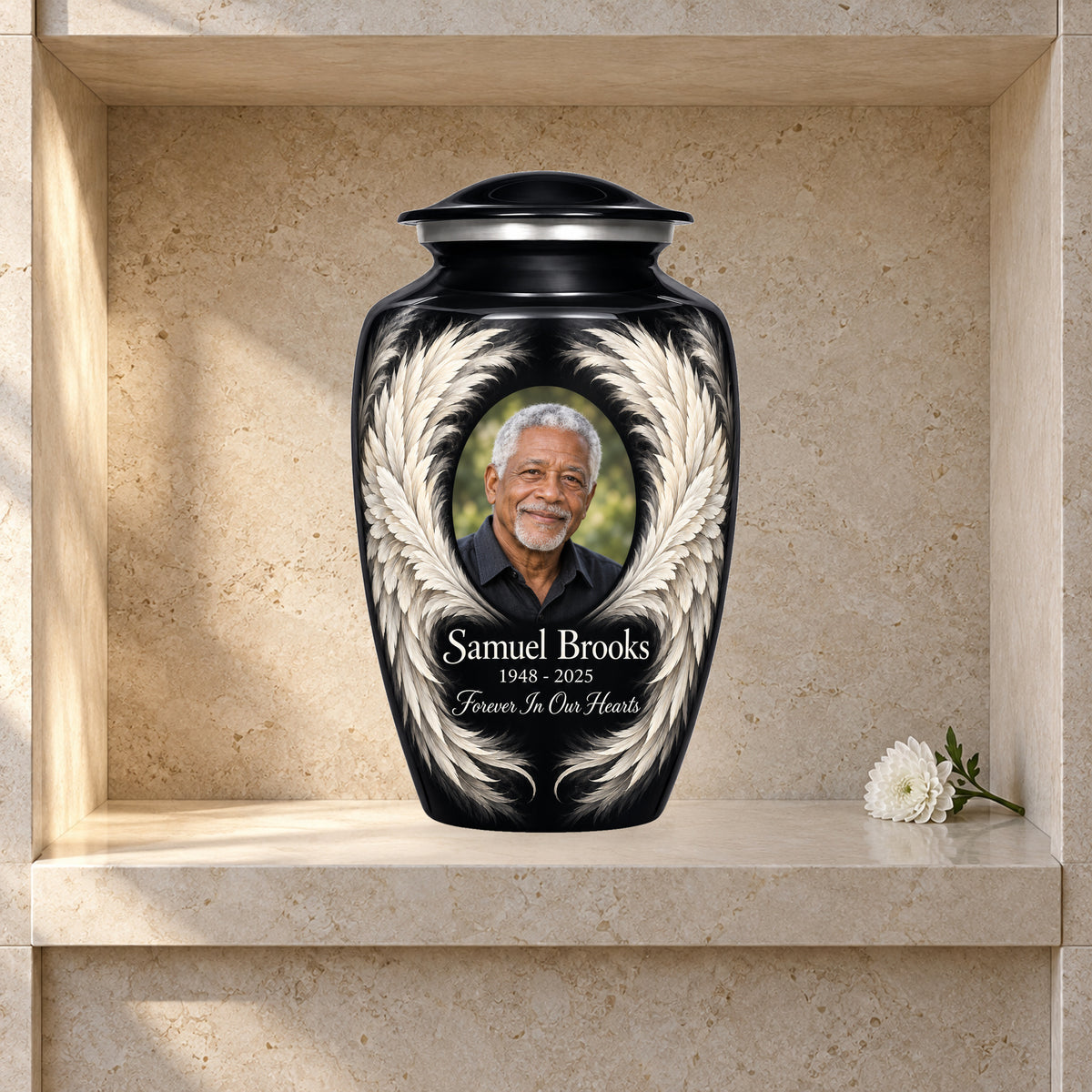 black adult urn with Ivory Sweep Wings angel wings artwork displayed in a columbarium niche.