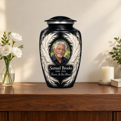 black personalized angel wings adult urn on a memorial console.
