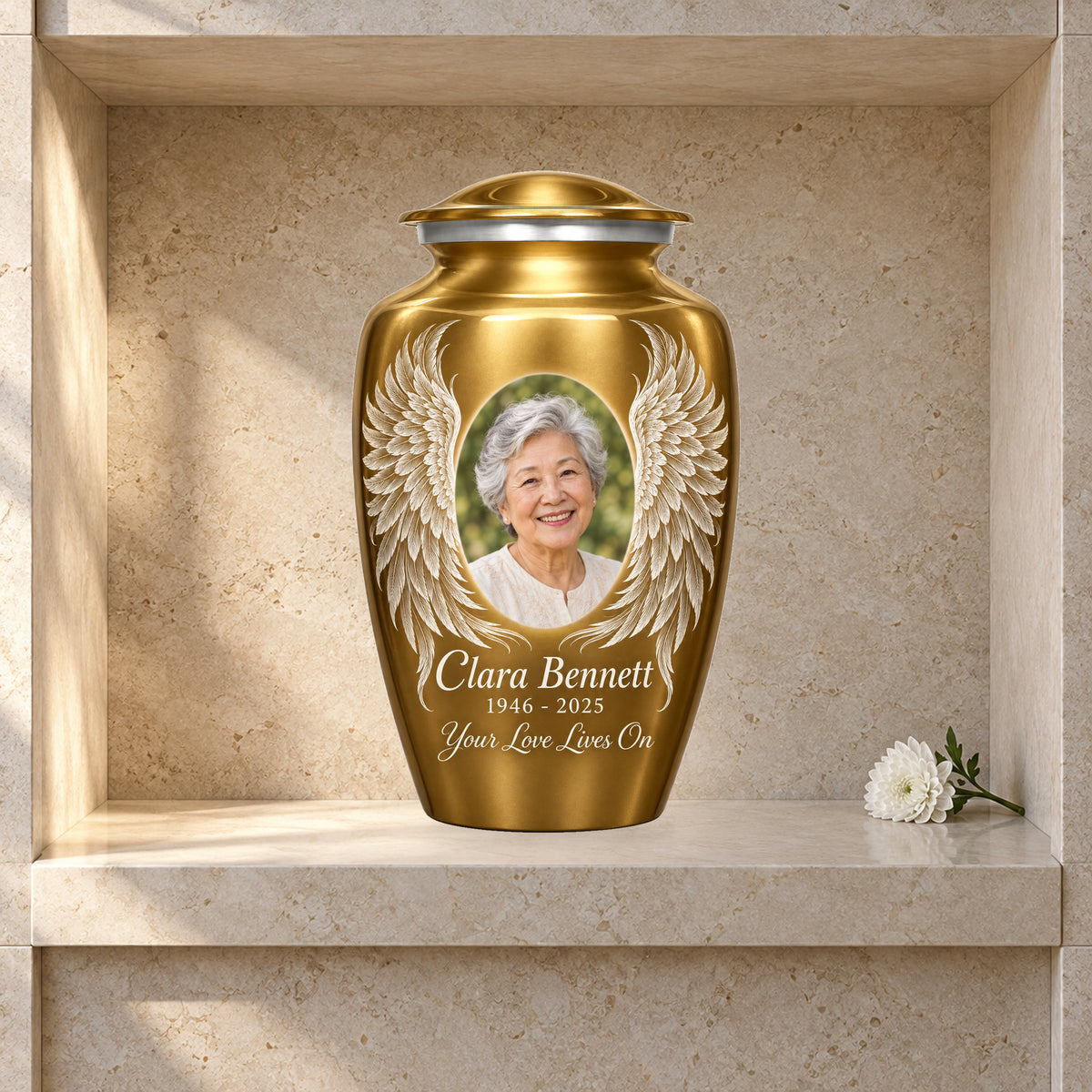 gold adult urn with Golden Etched Wings angel wings artwork displayed in a columbarium niche.