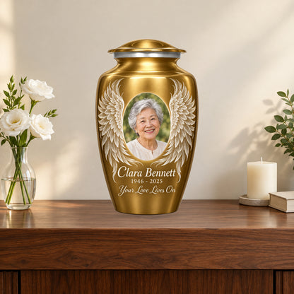 gold personalized angel wings adult urn on a memorial console.