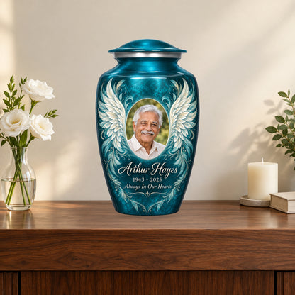 blue personalized angel wings adult urn on a memorial console.