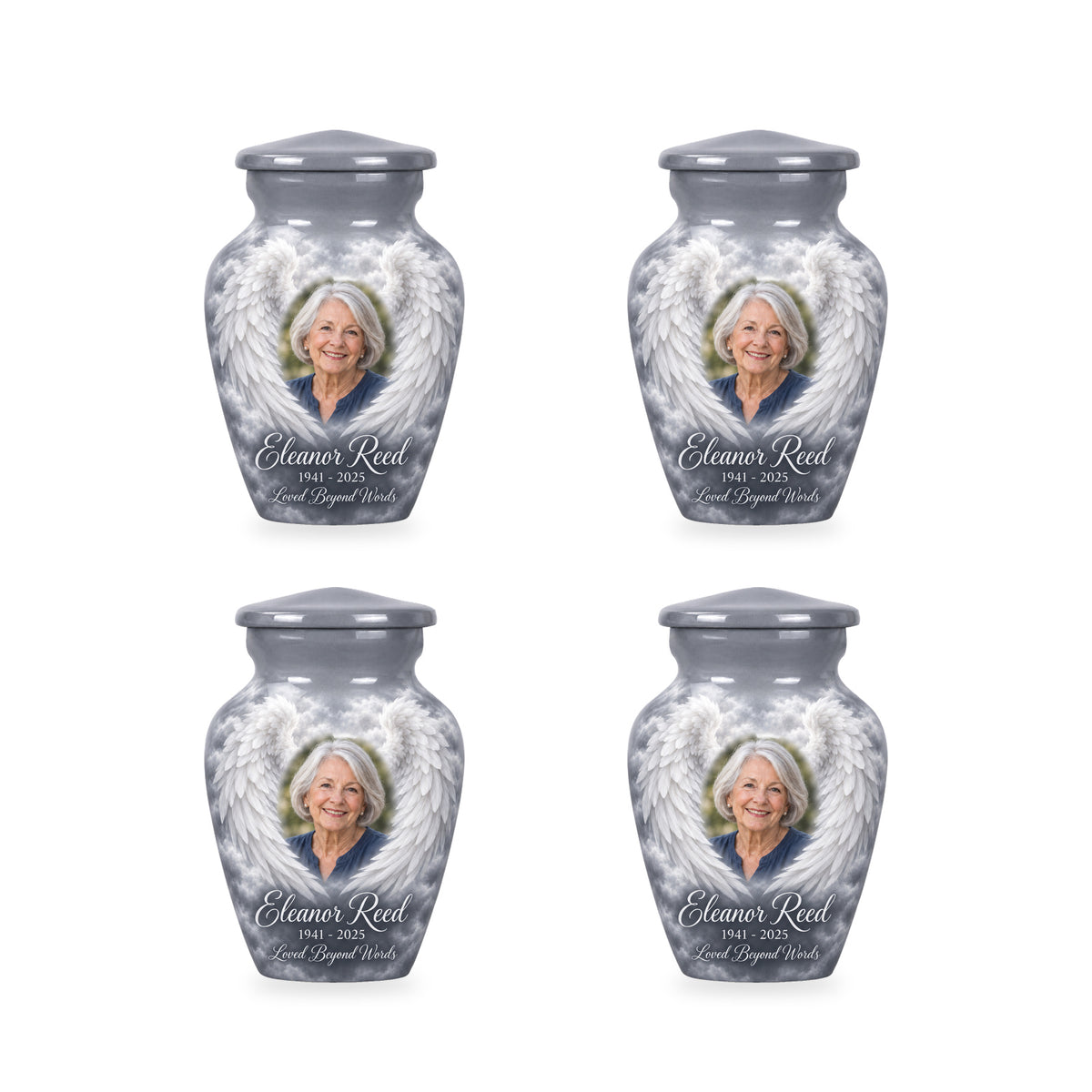 Four matching gray angel wings keepsake urns with sample photo and inscription.