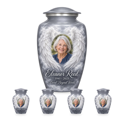 gray adult angel wings urn with four matching keepsakes shown in proportional 10-inch and 3-inch sizes.