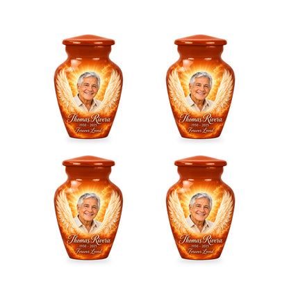 Four matching orange angel wings keepsake urns with sample photo and inscription.
