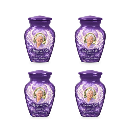Four matching purple angel wings keepsake urns with sample photo and inscription.