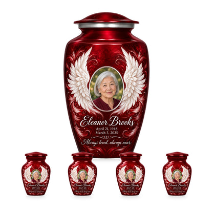 red adult angel wings urn with four matching keepsakes shown in proportional 10-inch and 3-inch sizes.