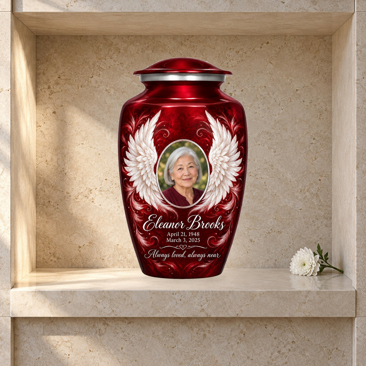 red adult urn with Crimson Uplifted Wings angel wings artwork displayed in a columbarium niche.